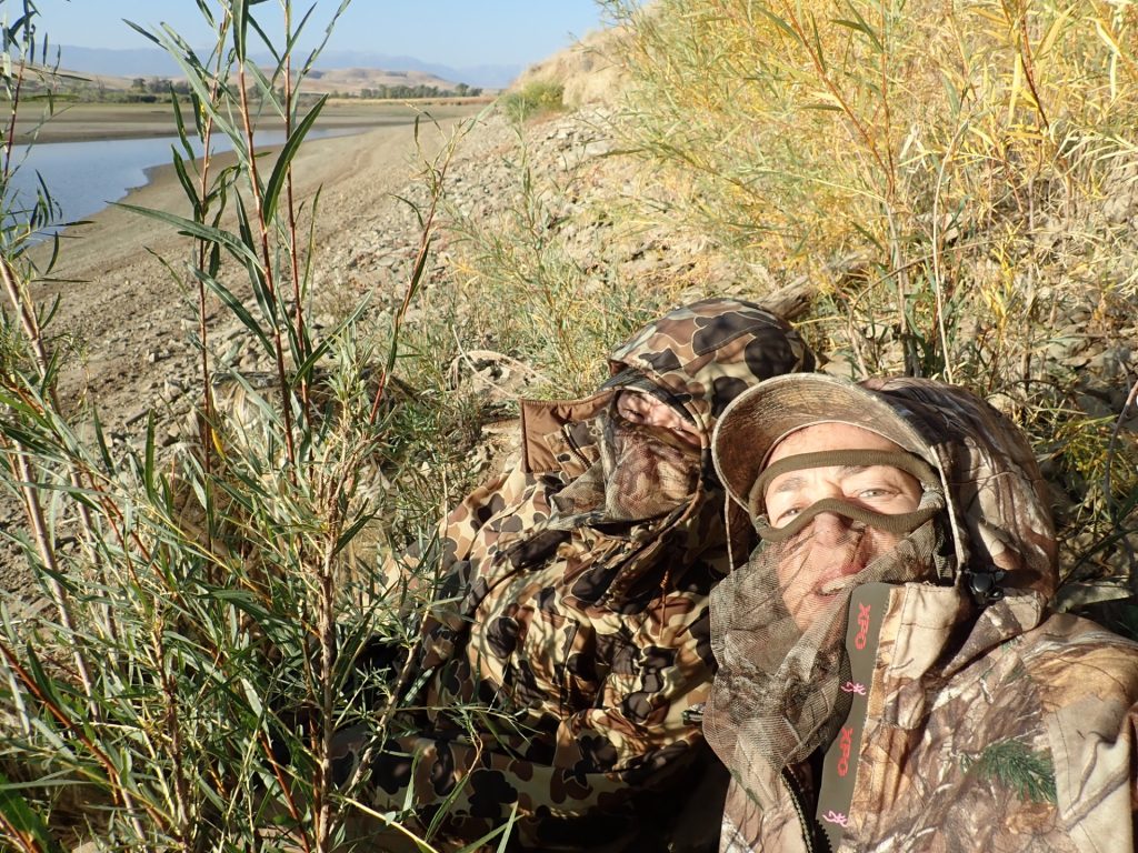Lisa Ballard laying in a grassy field.