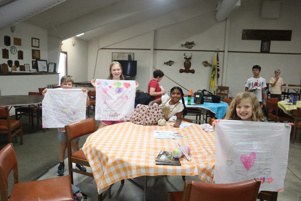 Pictures of children holding up their projects from Conservation Summer Camp.