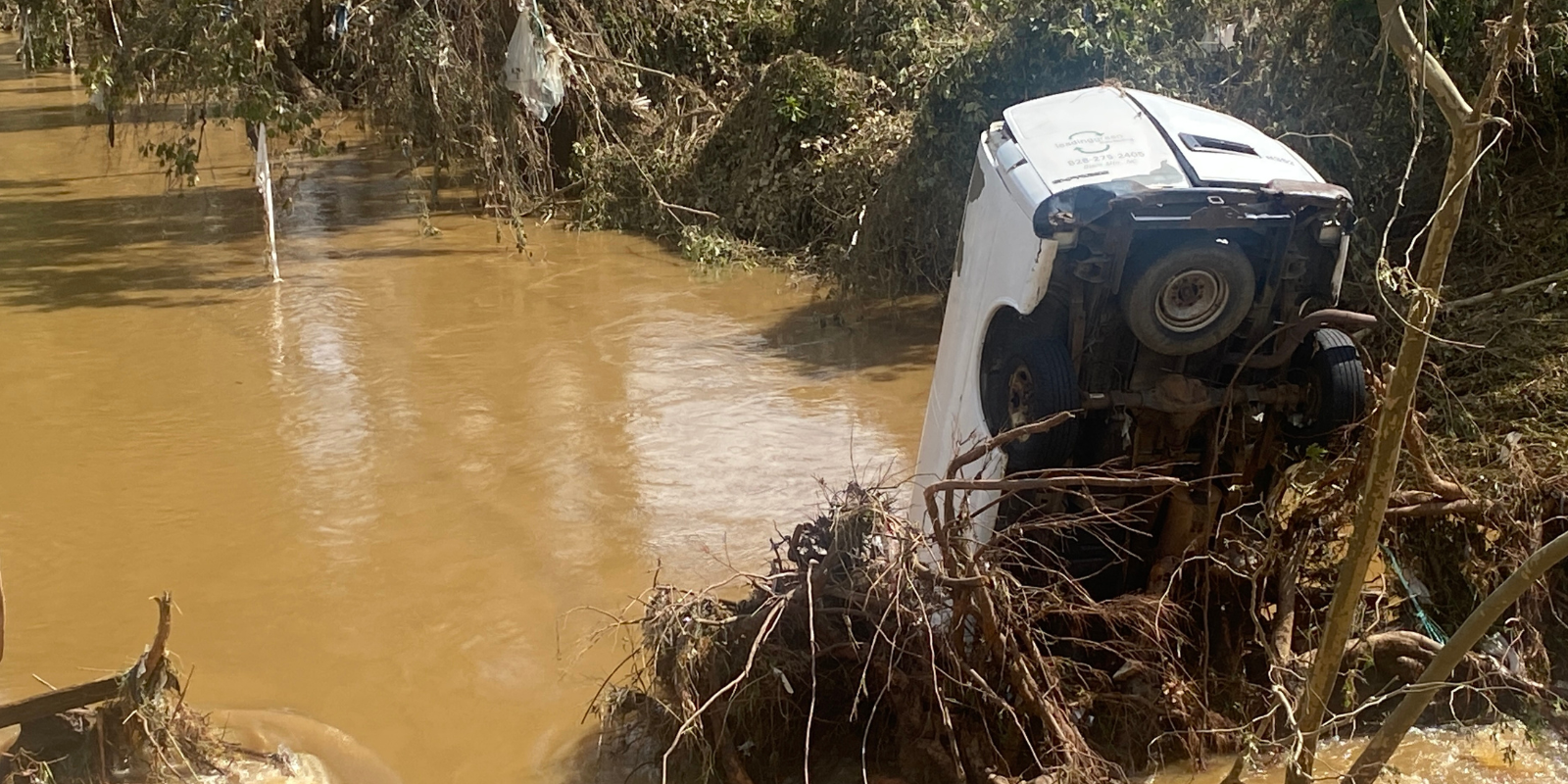 Van in a River after a significant flooding event.